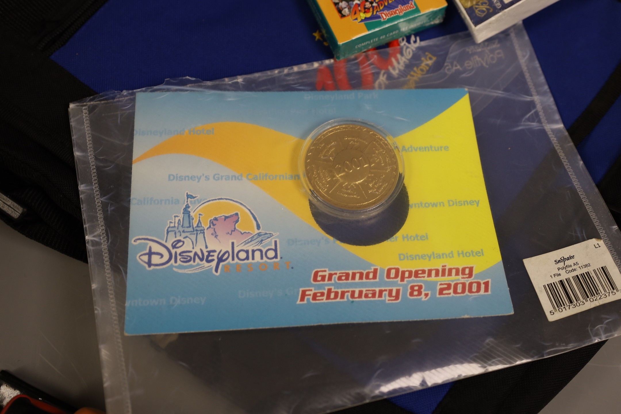 Commemorative coin, Millenium timepiece, Christmas tree ornament, bookmark, limited edition gatepasses to Disneyland, California - all Walt Disney related; also Disney canvas bag